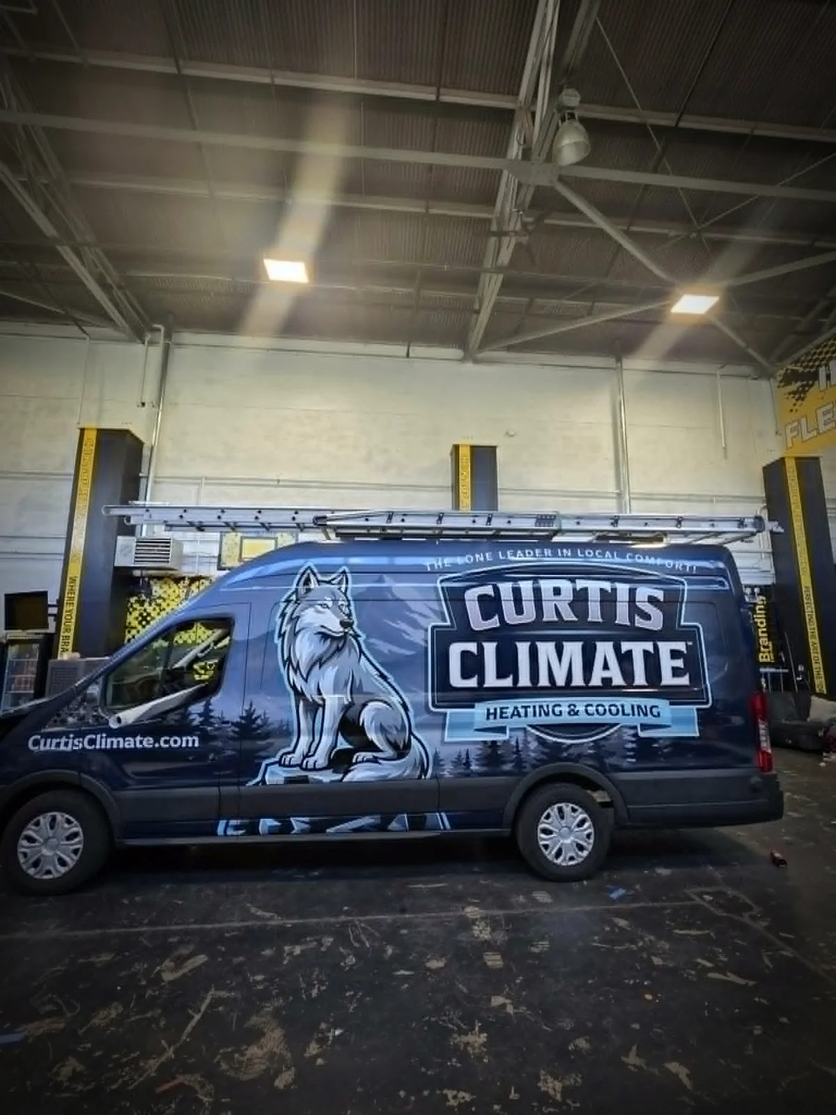 Curtis Climate van after, full color-change wrap with wolf identity